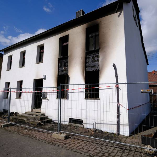 Das Bild zeigt das Gebäude mit rußgeschwärzter Fassade am Morgen nach dem Brand.