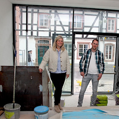 Zwei Männer und eine Frau stehen im Eingangsbereich des neuen Rathauses von Blankenheim, der noch eine Baustelle ist.