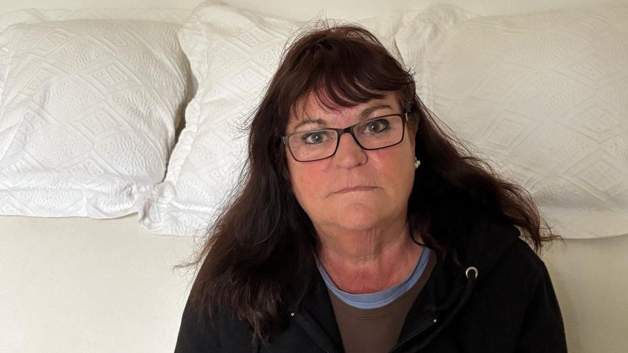 Lisa Müller sitzt auf ihrer Couch.