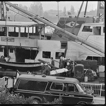 Auf einer Bahre tragen Feuerwehrleute eines der Todesopfer aus dem geborgenen Wrack des Kabinenschiffs „Prinses Irene“.