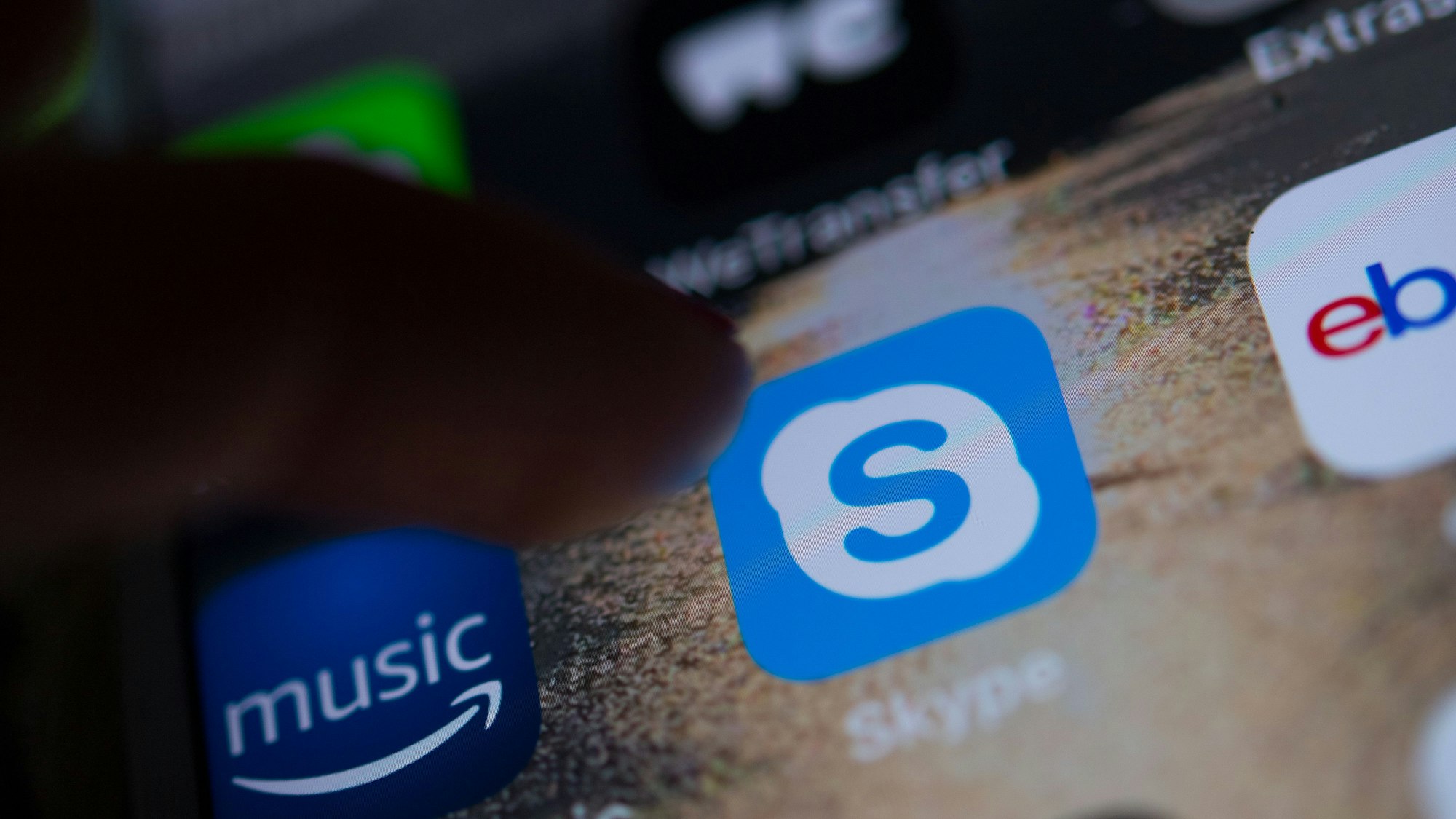 Das Logo der App des Messengers Skype ist auf dem Display eines Smartphones zu sehen.