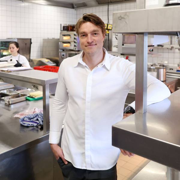 Ein Mann - er ist Küchenchef - steht in der Küche eines Restaurants.