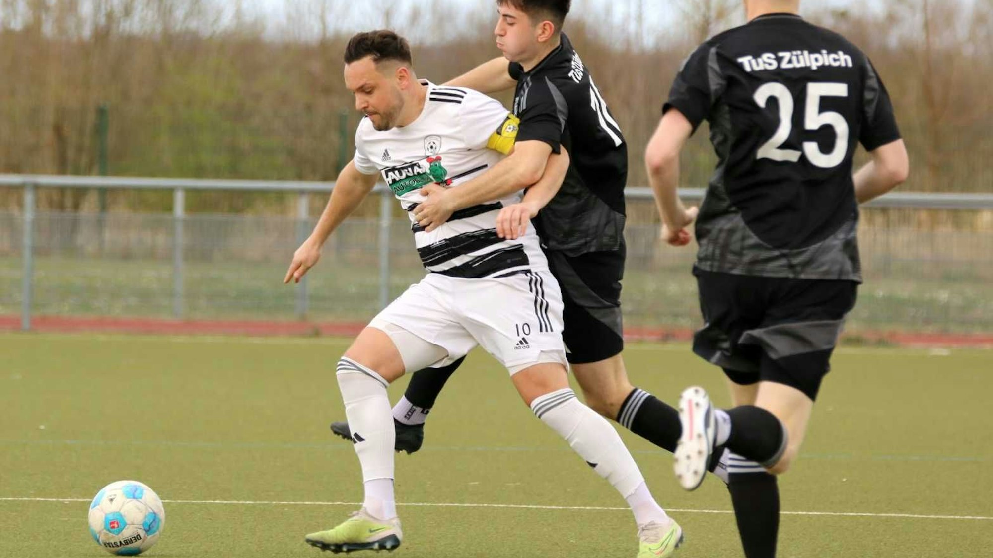 Zülpichs Johannes Püllen springt von hinten Pascal Schiffer an, der den Ball vor ihm verteidigt.