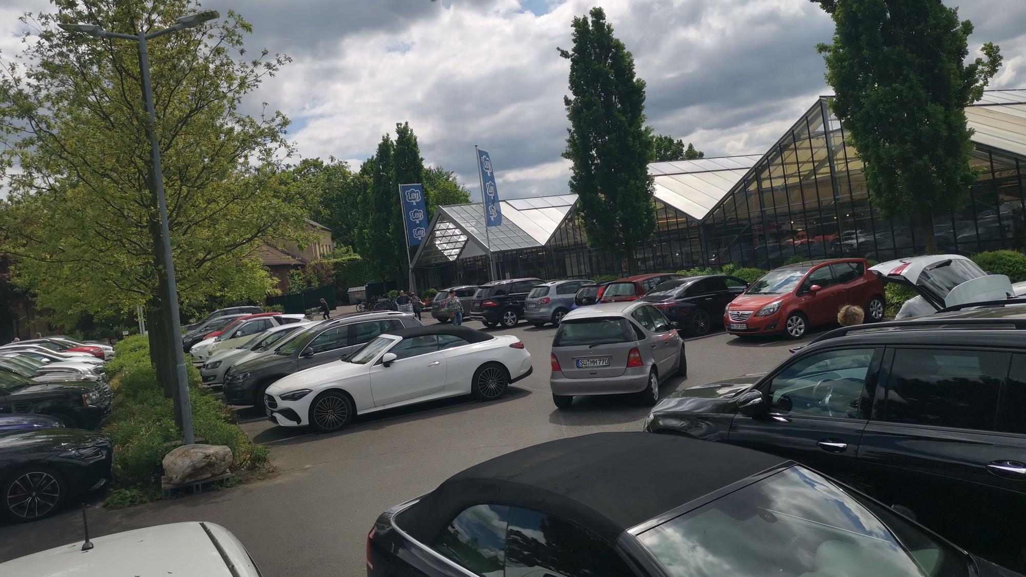 Blick auf den Parkplatz und die große Halle des Gartencenters Ley.