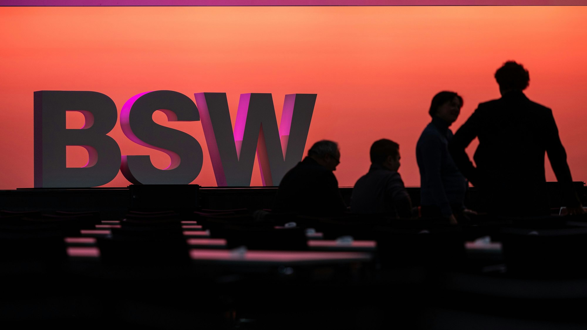 Teilnehmer stehen vor einem BSW Schriftzug.