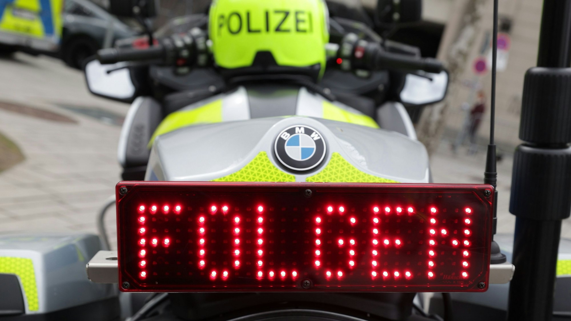 Auf einem Display am Heck eines Polizeimotorrads ist das Wort «Folgen» zu lesen.