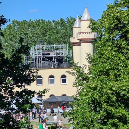 Das Foto zeigt die Moschee in Alt-Hürth mit der eingerüsteten Kuppel und den beiden Minaretten.