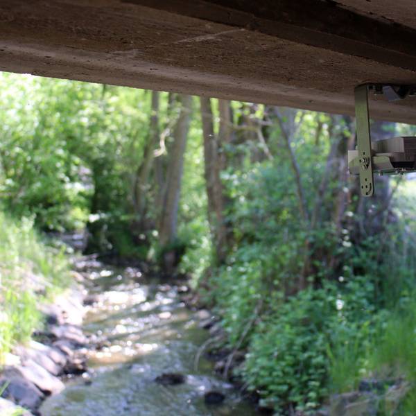 Eine kleine Kamera ist unter einer Brücke installiert. Unten fließt der Eschweiler Bach mit niedrigem Wasserstand.