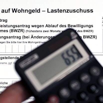 Ein Wohngeldantrag auf dem Bildschirm eines Laptops und ein Taschenrechner.