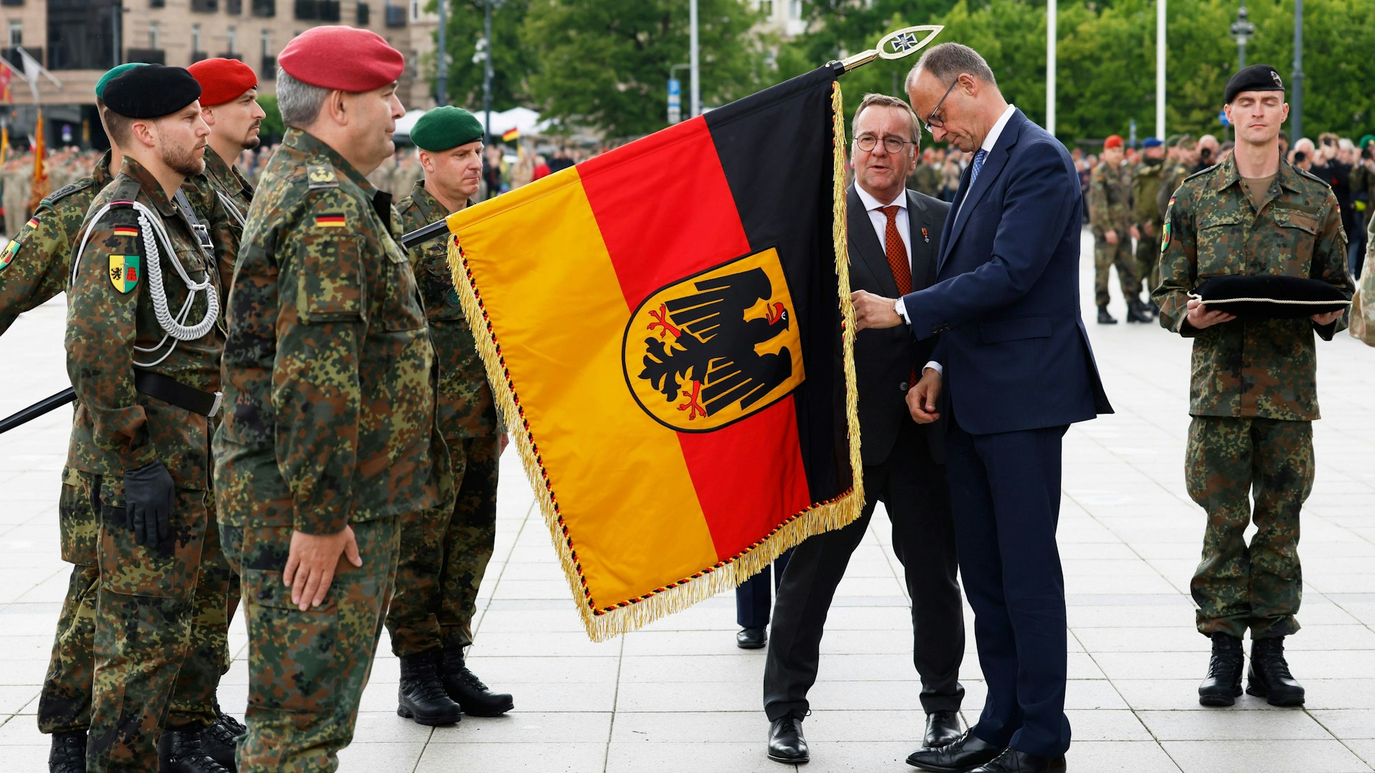 Litauen, Vilnius: Bundeskanzler Friedrich Merz (CDU, 2.v.r.) und Boris Pistorius (SPD, 3.v.r.), Verteidigungsminister, nehmen am Aufstellungsappell der Panzerbrigade 45 teil.