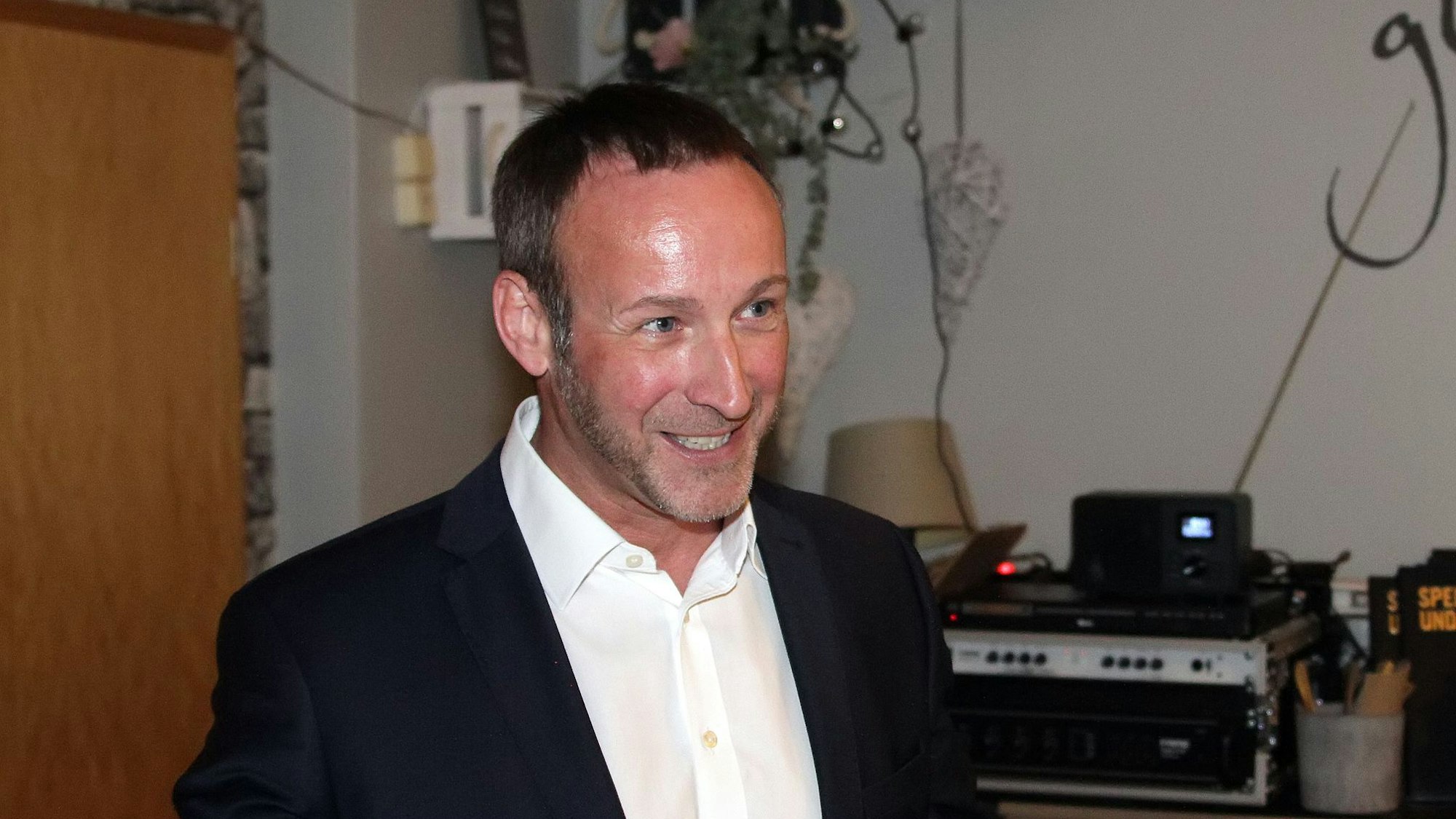 Ein Mann lächelt in die Kamera.