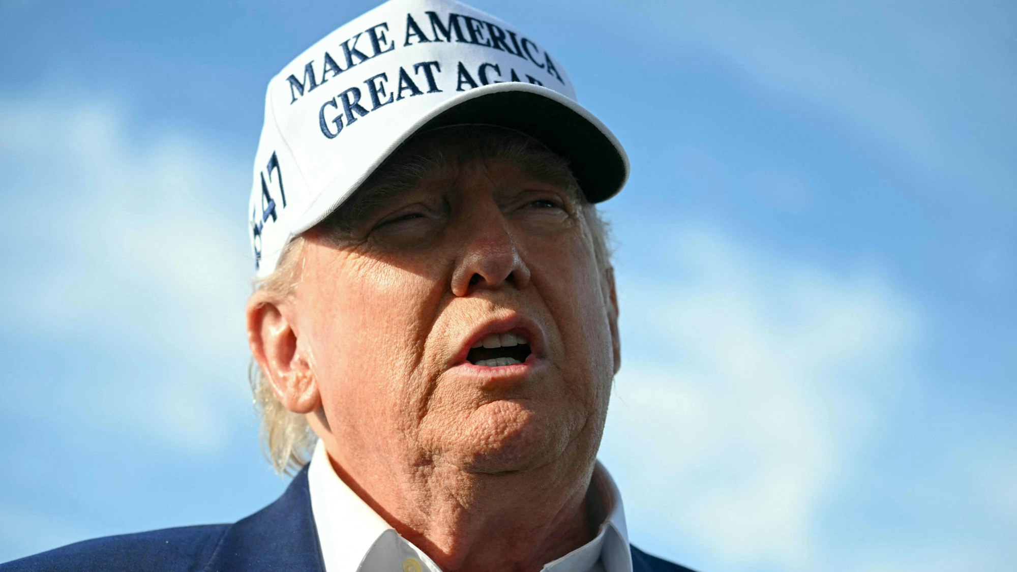 US President Donald Trump speaks to journalists before boarding Air Force One from Morristown Municipal Airport in Morristown, New Jersey, May 25, 2025, after spending the weekend in New Jersey. (Photo by SAUL LOEB / AFP)
