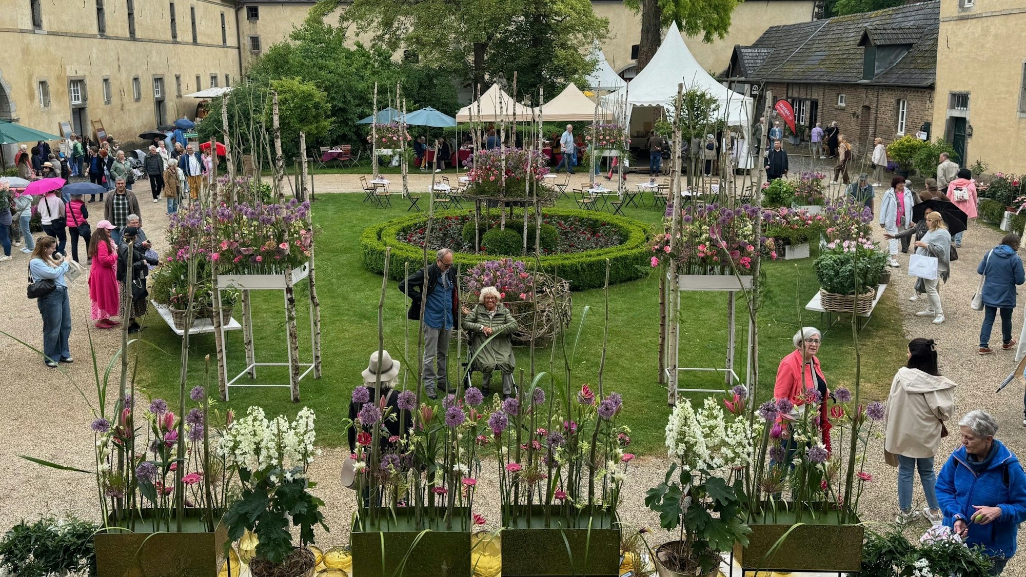 Blick in den mit Blumen geschmückten Innenhof der Wasserburg Adendorf.