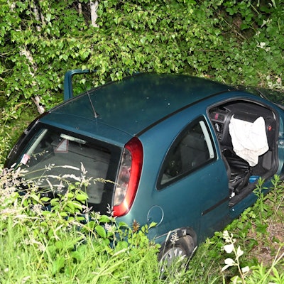 Das Bild zeigt ein Auto in einem Straßengraben.