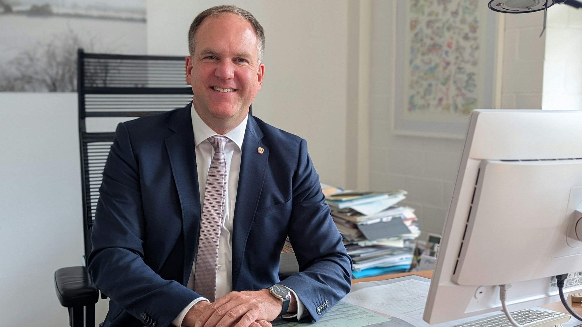 Das Foto zeigt Bürgermeister Dirk Breuer an seinem Schreibtisch im Rathaus.