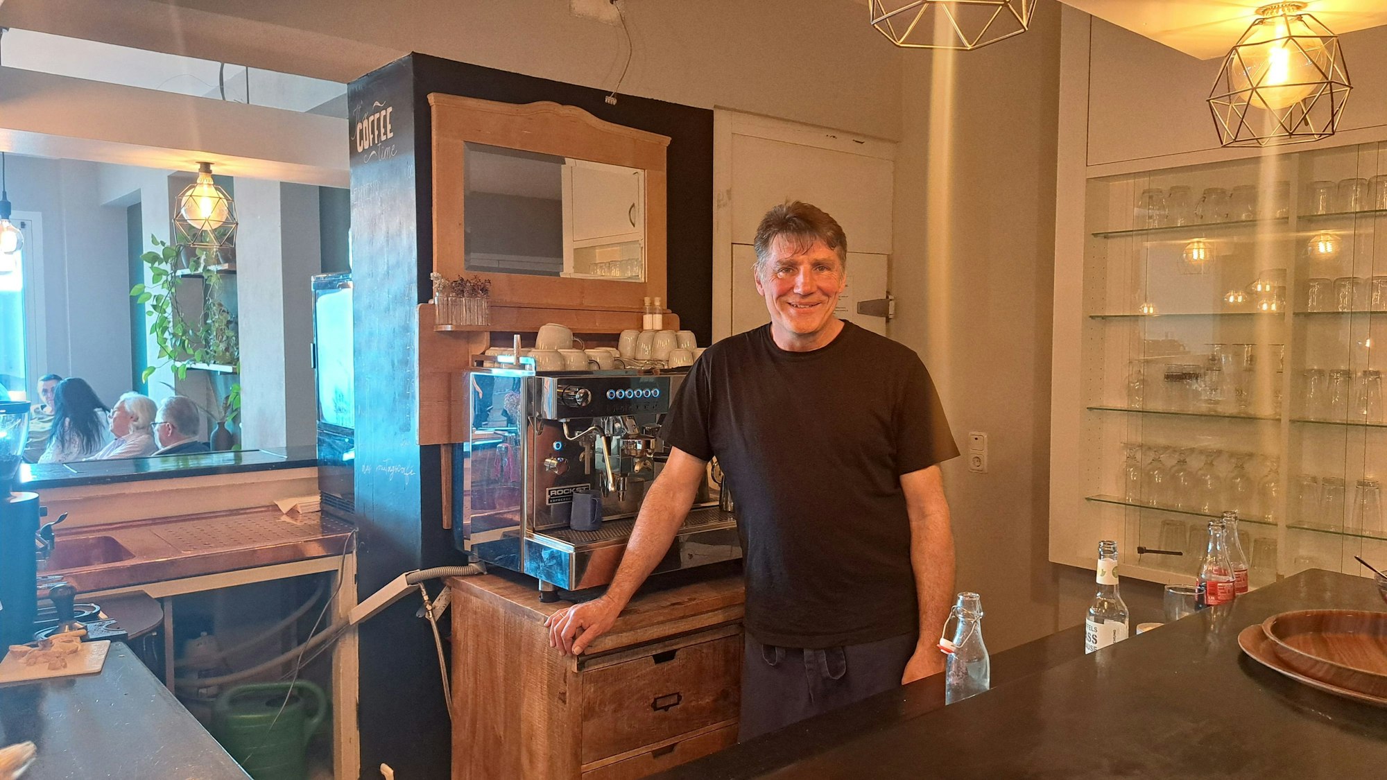 Ein Mann steht hinter einer Theke.