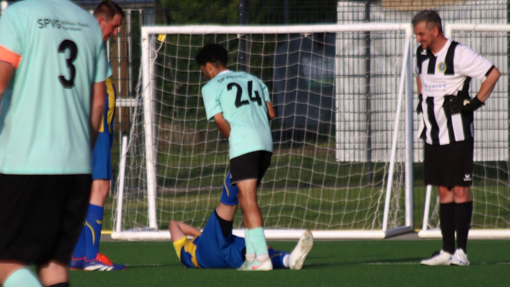 Gamito Manhembue als Helfer in der Not beim Krampf eines Kommerner Spielers.