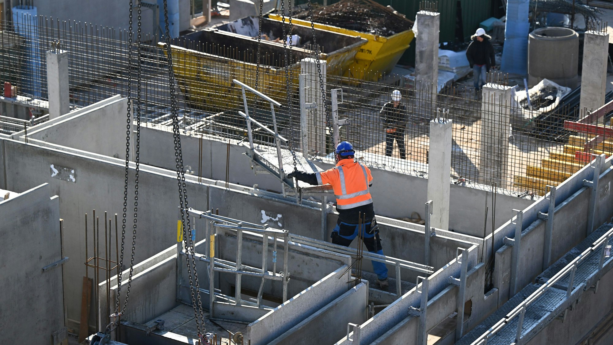 Bauarbeiter arbeiten am Rohbau eines Wohnhauses.