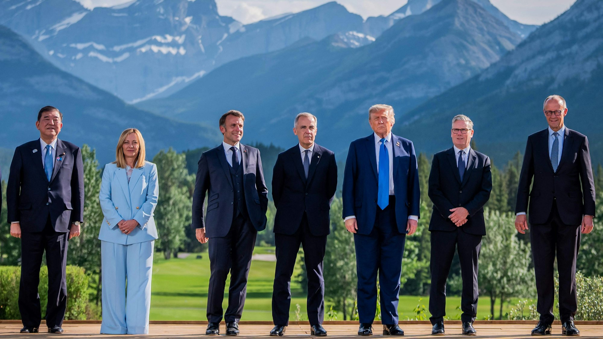 (L-R) Japanese Prime Minister Shigeru Ishiba, Italian Prime Minister Giorgia Meloni, French President Emmanuel Macron, Canadian Prime Minister Mark Carney, US President Donald Trump, British Prime Minister Keir Starmer and German Chancellor Friedrich Merz pose for a family photo during the Group of Seven (G7) Summit at the Kananaskis Country Golf Course in Kananaskis, Alberta, Canada on June 16, 2025. (Photo by Michael Kappeler / POOL / AFP)
