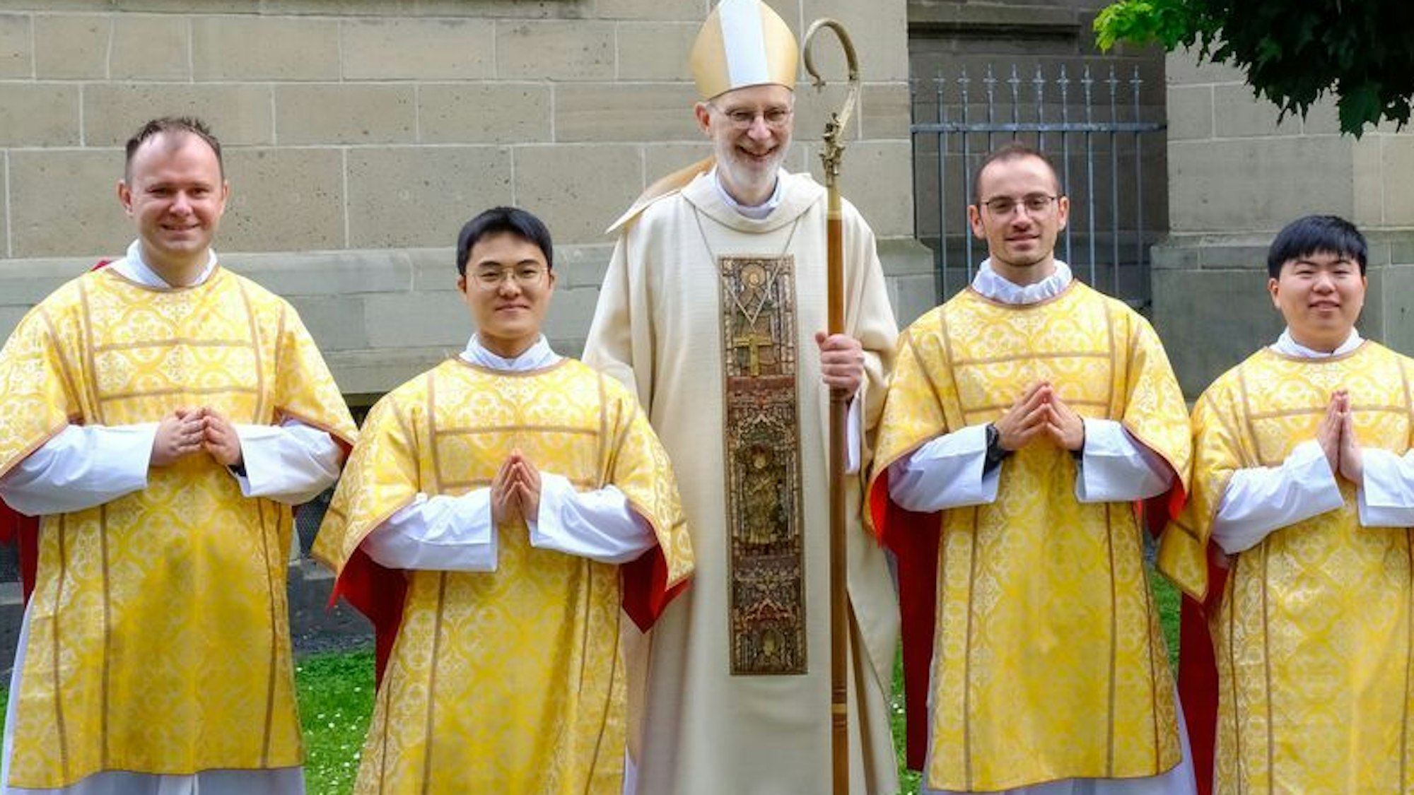 Die vier frisch geweihten Diakone haben sich mit dem Weihbischof zum Foto aufgestellt.