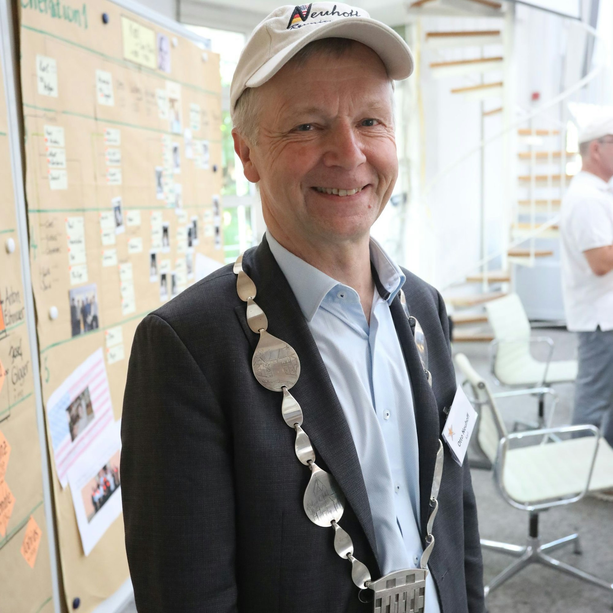 Bad Honnefs Bürgermeister im Ratssaal, im Hintergrund eine Stellwand mit Stammbäumen.