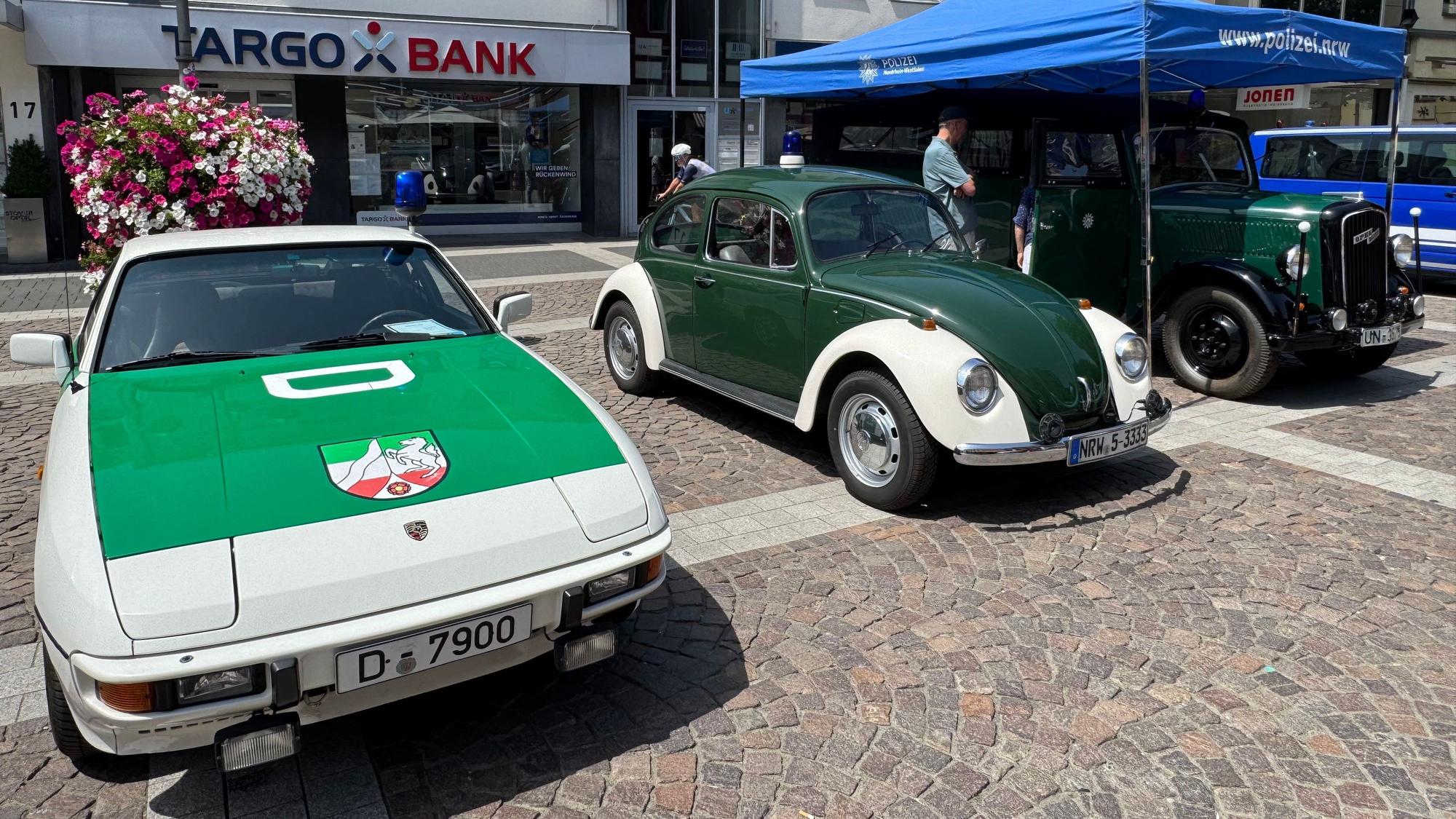 Auf dem Foto sind historische Fahrzeuge der Polizei zu sehen.
