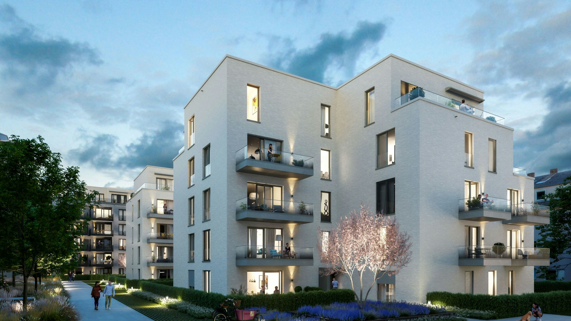 Mehrgeschossige Wohnblöcke mit Grünflächen und breiten Fußwegen sind zu sehen.