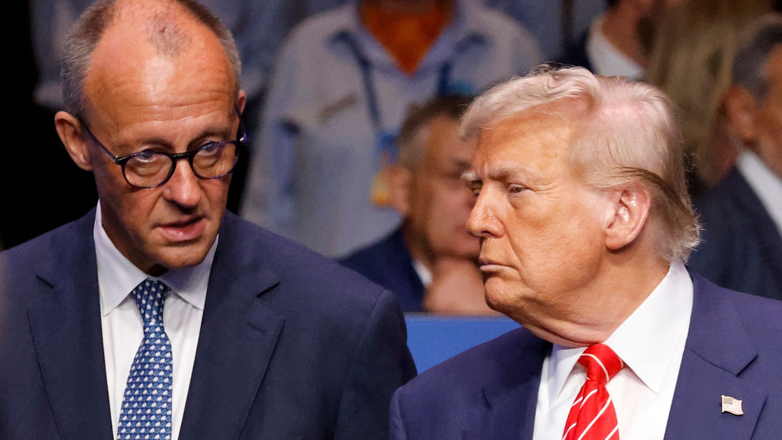 Germanys Chancellor Friedrich Merz (L) speaks with US President Donald Trump before the start of the North Atlantic Council plenary meeting at the North Atlantic Treaty Organisation (NATO) summit in The Hague on June 25, 2025. (Photo by Ludovic MARIN / POOL / AFP)