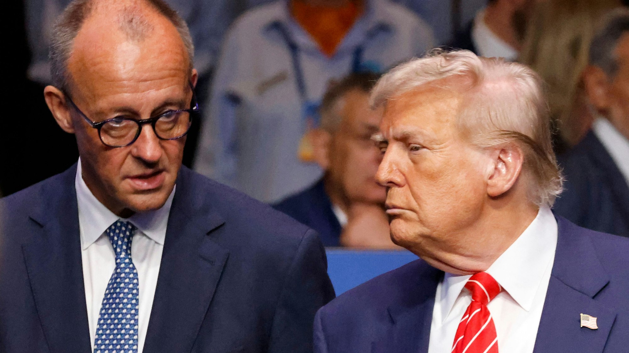 Germanys Chancellor Friedrich Merz (L) speaks with US President Donald Trump before the start of the North Atlantic Council plenary meeting at the North Atlantic Treaty Organisation (NATO) summit in The Hague on June 25, 2025. (Photo by Ludovic MARIN / POOL / AFP)