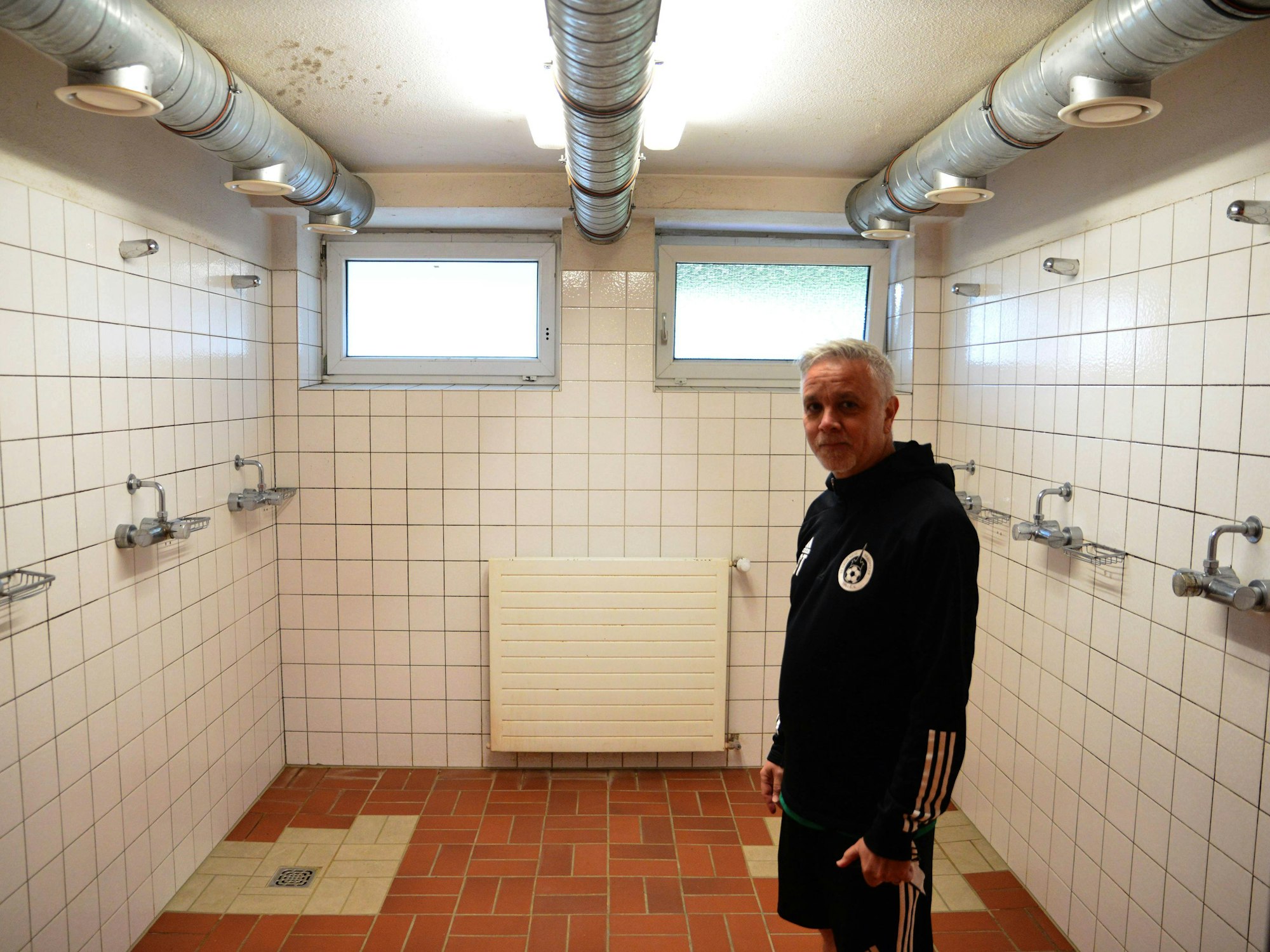 Das Bild zeigt Sascha Theisen in der Gemeinschaftsdusche.