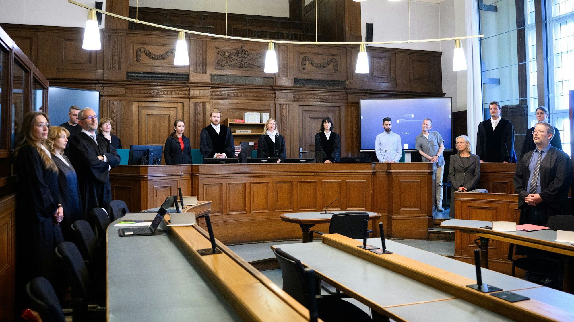 Die Vorsitzende Richterin Sylvia Busch (M) und Staatsanwalt Philipp Meyhöfer (2.v.r.) stehen beim Mordprozess gegen einen Palliativarzt, der in Berlin 15 Menschen getötet haben soll, im Landgericht Berlin.