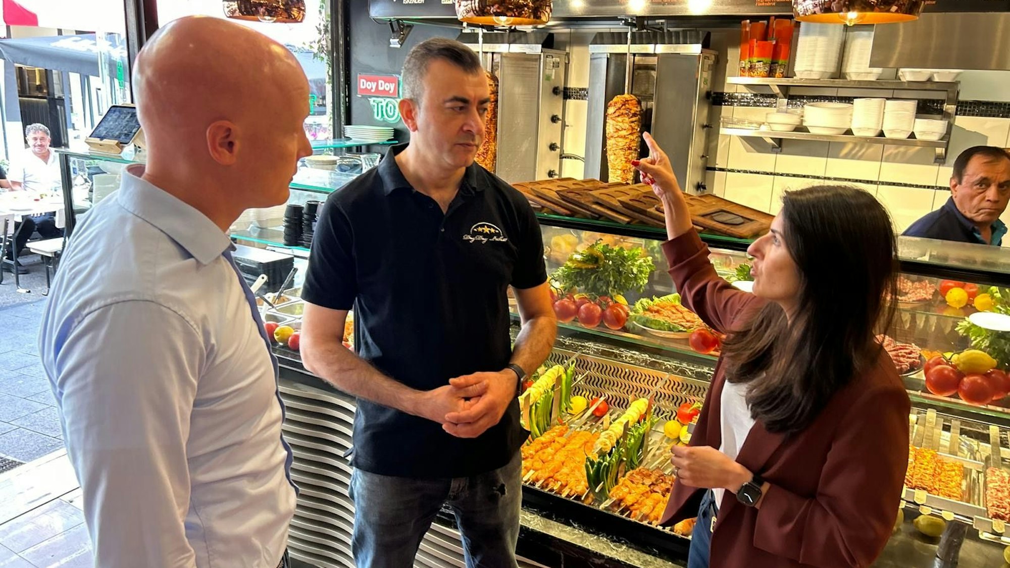 Ortstermin auf der Weidengasse: Serap Güler im Gespräch mit „Doy Doy“- Chef Mehmet Harmanci (Mitte). Links CDU-Mitglied Florian Weber.