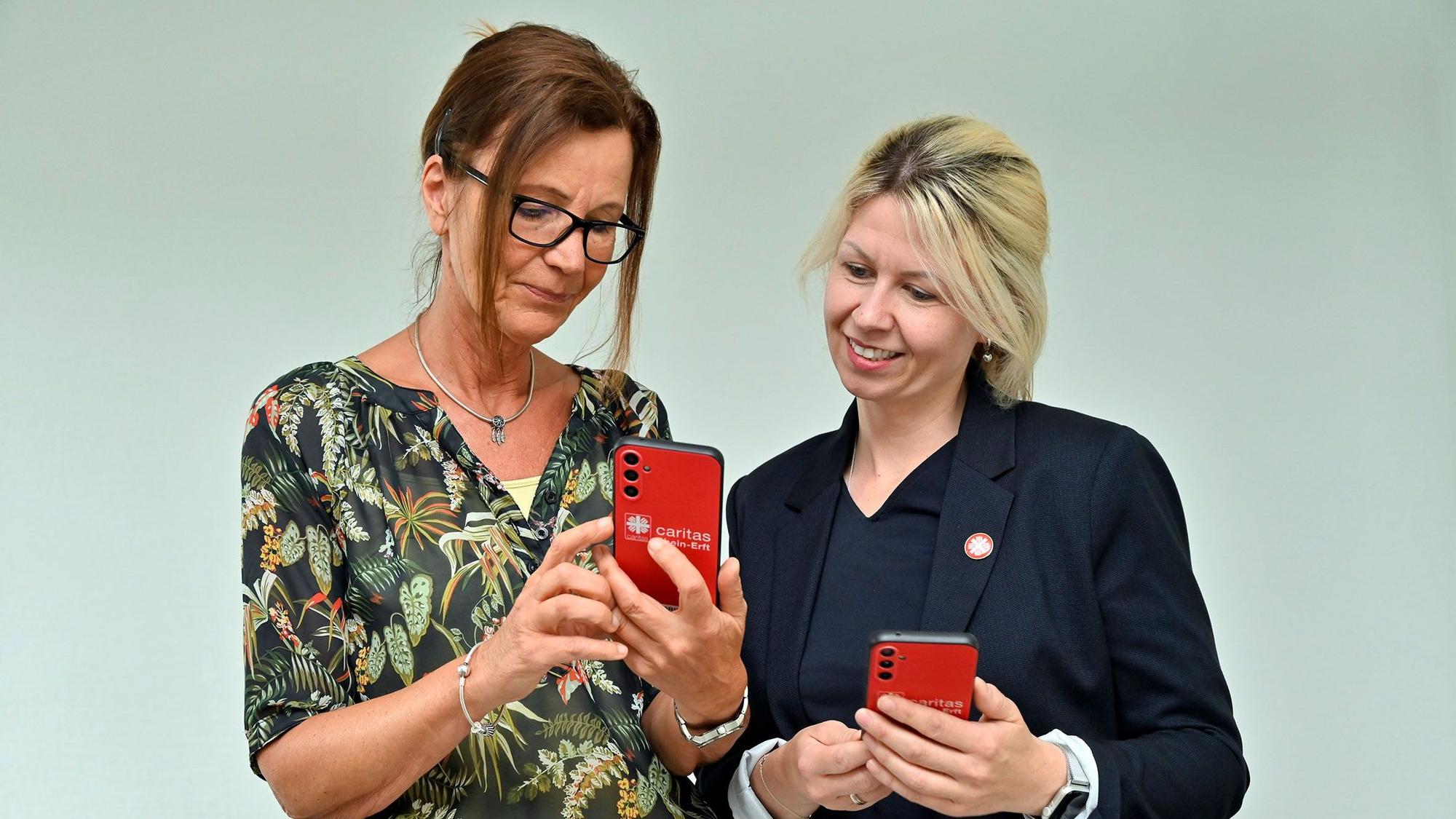 Führen bei der Caritas Rhein-Erft eine KI-gestützte Software ein, mit der die Pflegearbeit direkt per Spracheingabe dokumentiert wird: Caritas-Mitarbeitende Anette Decker (li.) und Stephanie Helmer, Leiterin des Fachbereichs Pflege.