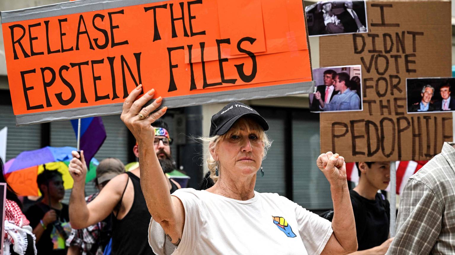 People holds signs calling for the release of files regarding late sex offender Jeffrey Epstein participate in a protest
