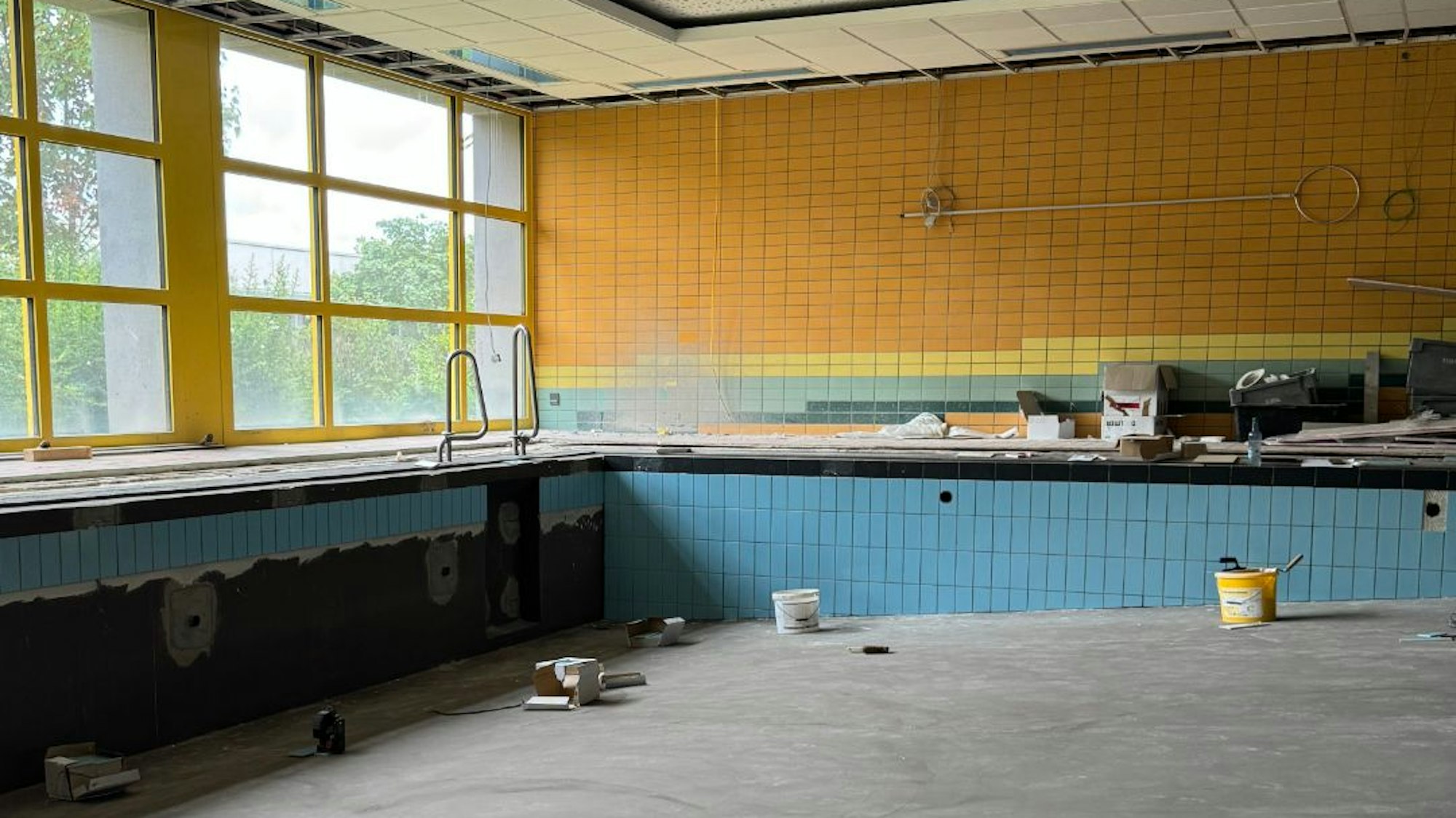 Im Lehrbecken werden nach der erfolgreichen Dichtigkeitsprüfung Fliesen angebracht.