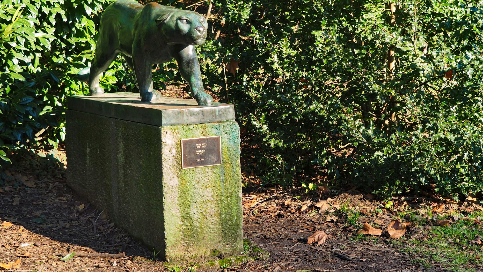 Auf einem Steinsockel steht die Skulptur eines Panters.