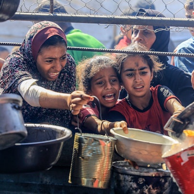 Palästinensische Kinder versuchen sich bei einer Ausgabestelle für Hilfslieferungen Nahrung zu sichern. Die humanitäre Lage im Gazastreifen hat sich drastisch verschärft. (Archivbild)