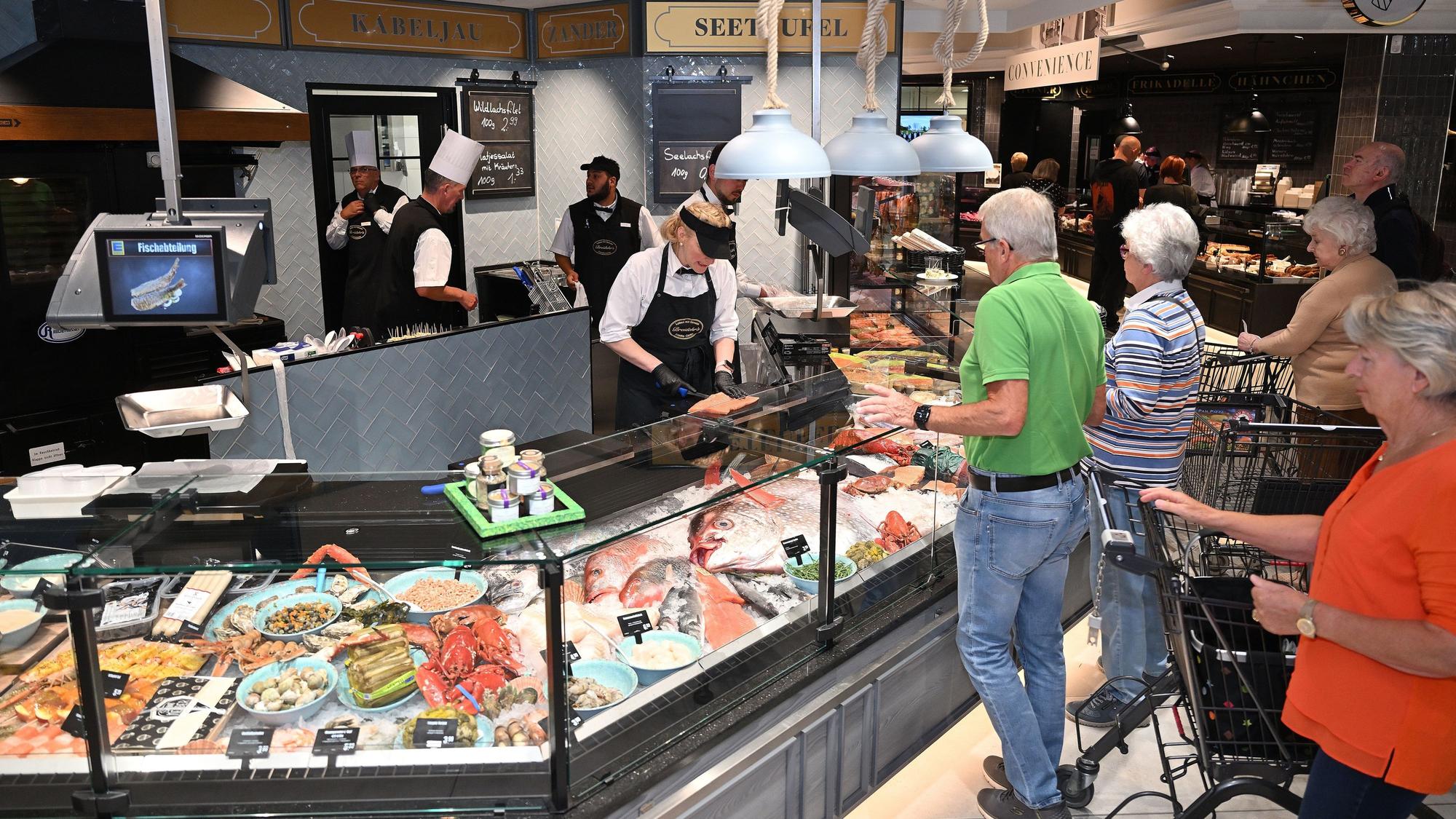 Die Kunden testen die neue Fischtheke am Tag der Eröffnung aus.