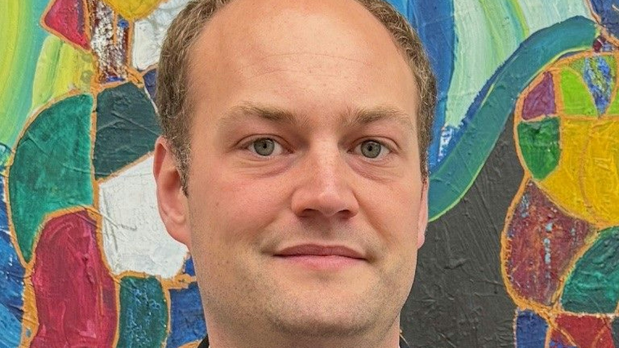 Porträtfoto vor einer bunten Wand