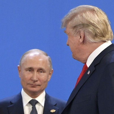 (FILES) US President Donald Trump (R) looks at Russia's President Vladimir Putin before posing for a family photo during the G20 Leaders' Summit in Buenos Aires, on November 30, 2018. US President Donald Trump said on August 8, 2025 he would meet with Russian counterpart Vladimir Putin on August 15 in Alaska, as the Republican billionaire hopes to help mediate an end to the war in Ukraine. (Photo by Juan Mabromata / AFP)