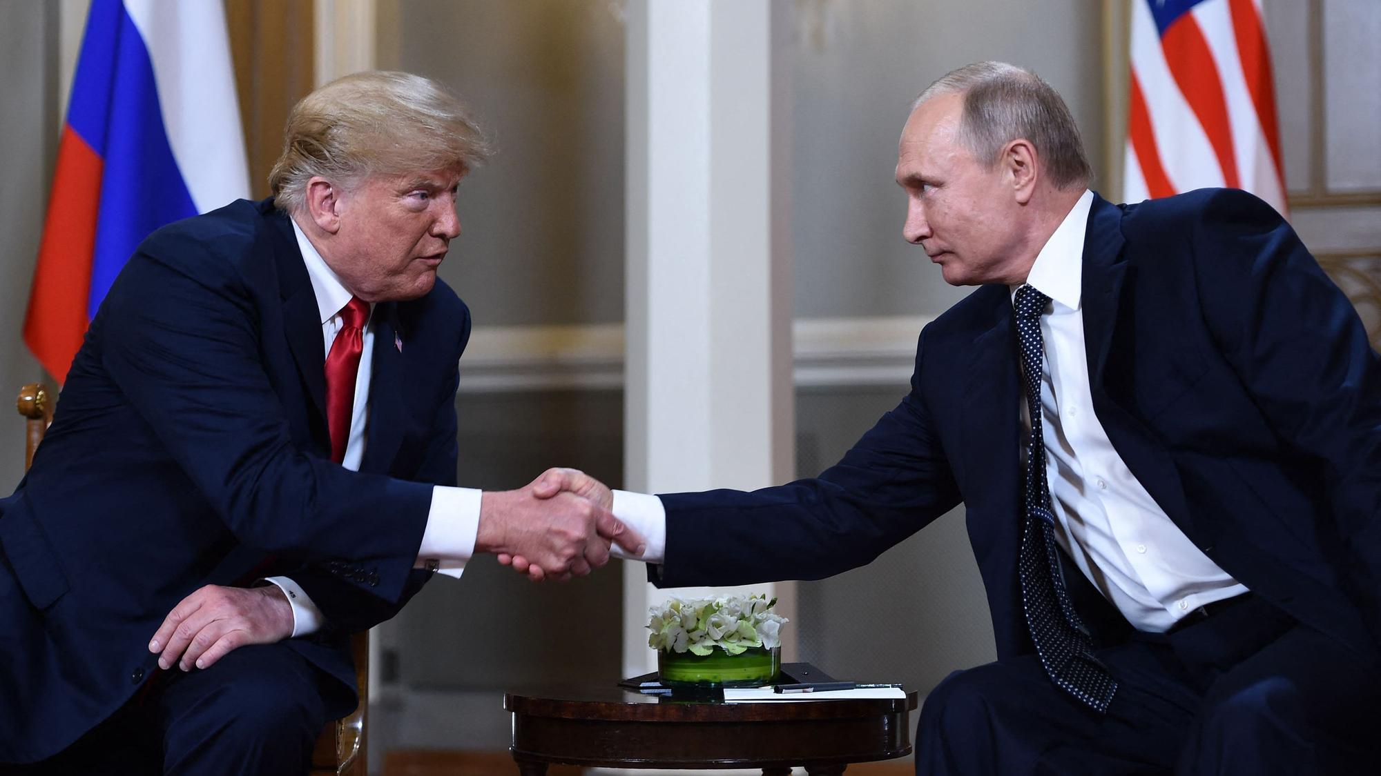 (FILES) Russian President Vladimir Putin (R) and US President Donald Trump shake hands before a meeting in Helsinki on July 16, 2018. US President Donald Trump said on August 8, 2025 he would meet with Russian counterpart Vladimir Putin on August 15 in Alaska, as the Republican billionaire hopes to help mediate an end to the war in Ukraine. (Photo by Brendan Smialowski / AFP)