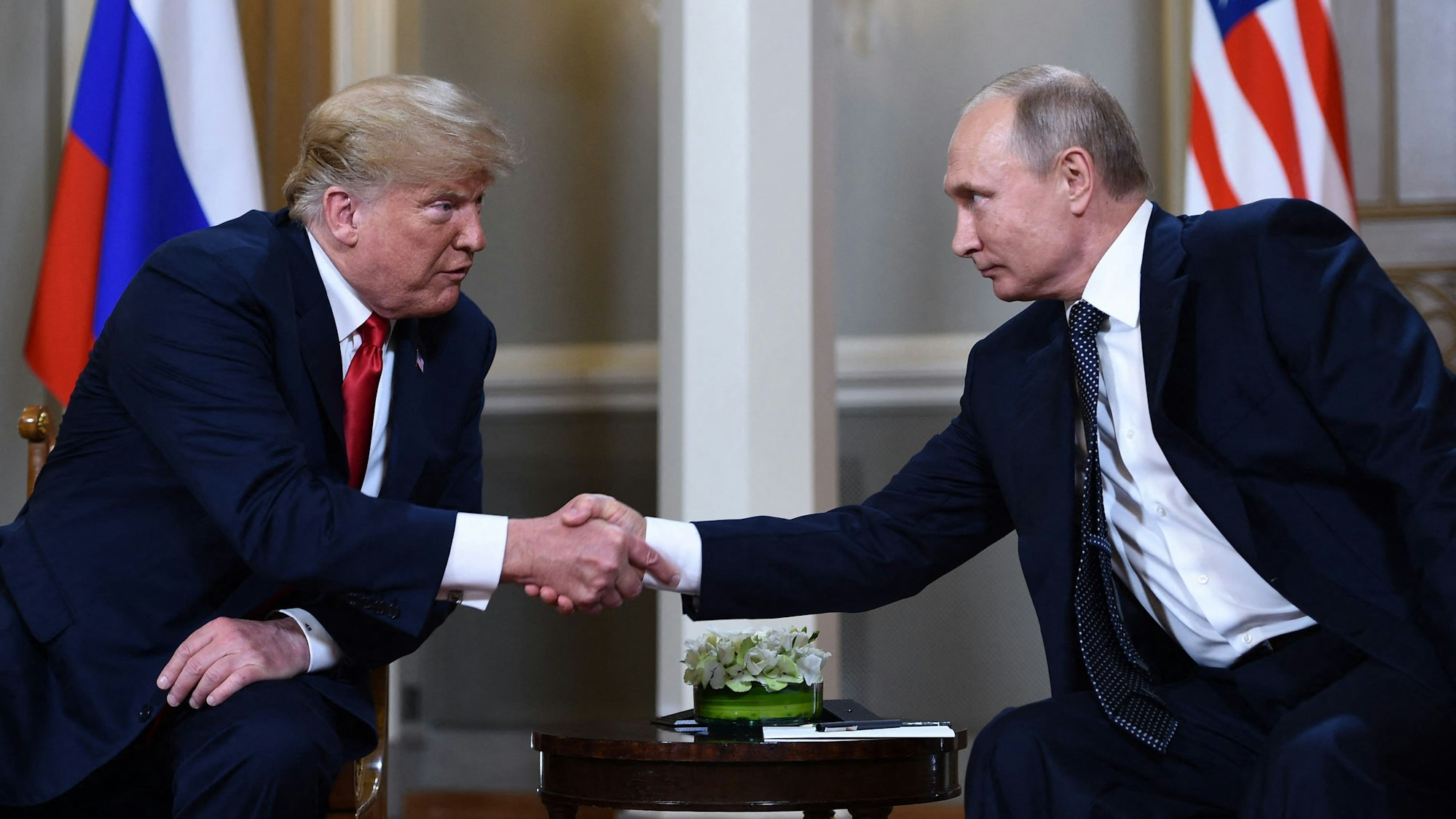 (FILES) Russian President Vladimir Putin (R) and US President Donald Trump shake hands before a meeting in Helsinki on July 16, 2018. US President Donald Trump said on August 8, 2025 he would meet with Russian counterpart Vladimir Putin on August 15 in Alaska, as the Republican billionaire hopes to help mediate an end to the war in Ukraine. (Photo by Brendan Smialowski / AFP)