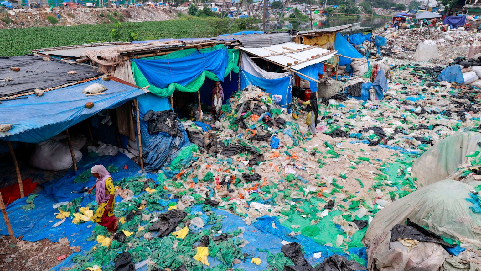 Bangladesch, Dhaka: Arbeiterinnen sortieren und trocknen gebrauchte Plastiktüten, nachdem sie sie in einer informellen Recyclinganlage in Dhaka, Bangladesch, gewaschen haben.