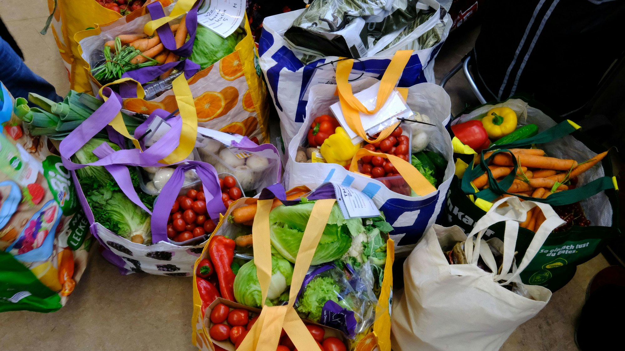 Bei der Mechernicher Tafel stehen vorgepackte Taschen mit Gemüse zur Abholung bereit.
