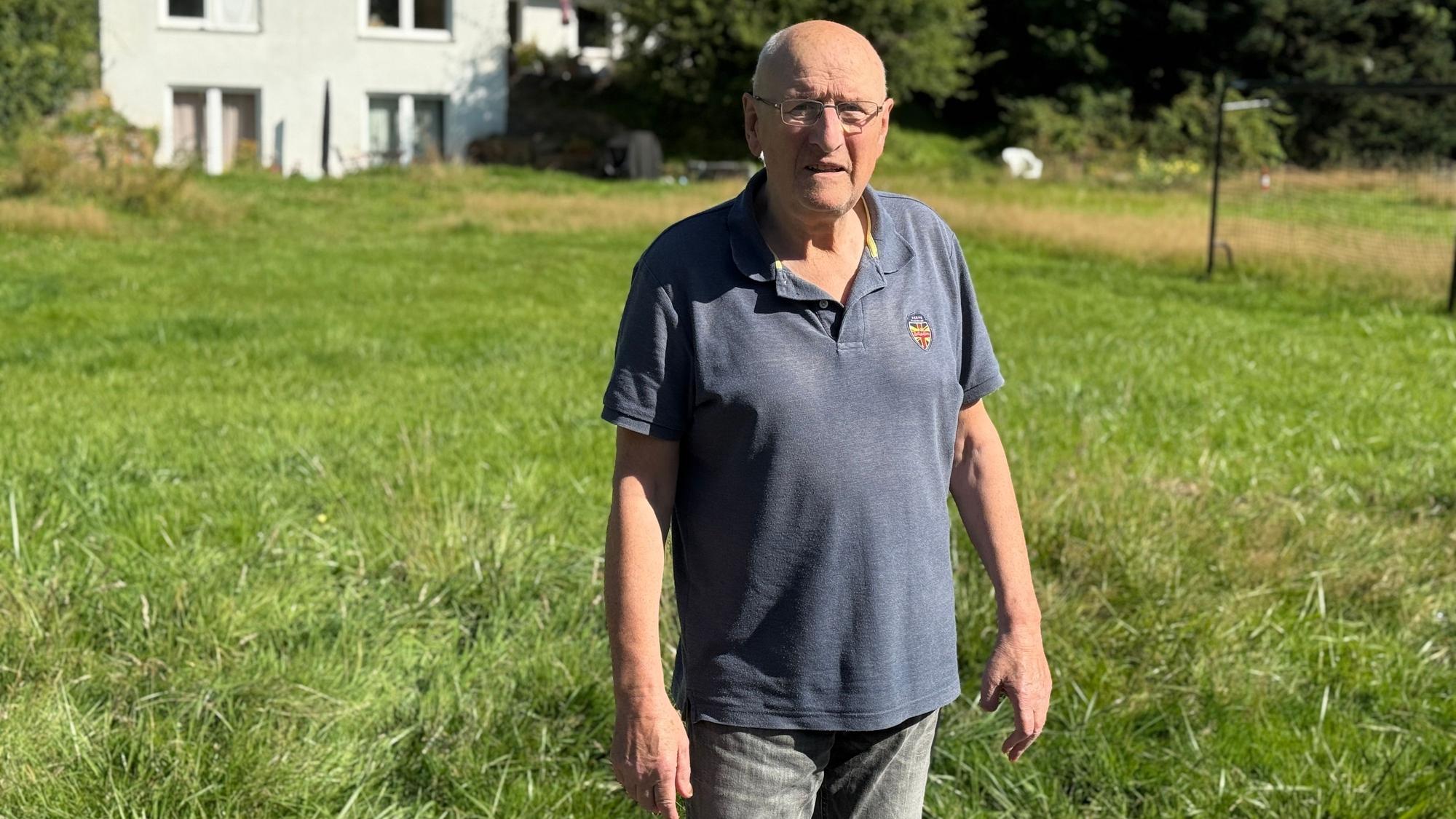 Ulrich Weuffel steht auf einer Wiese.