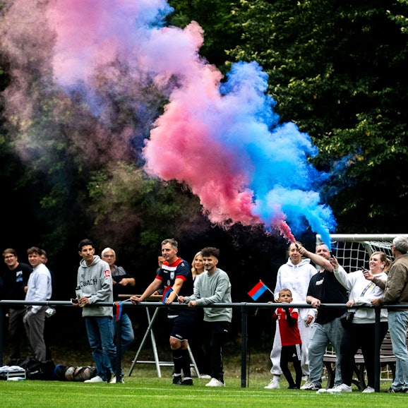 Ein Fan von Wüschheim-Büllesheim hat eine rot-blaue Rauch-Fackel gezündet.