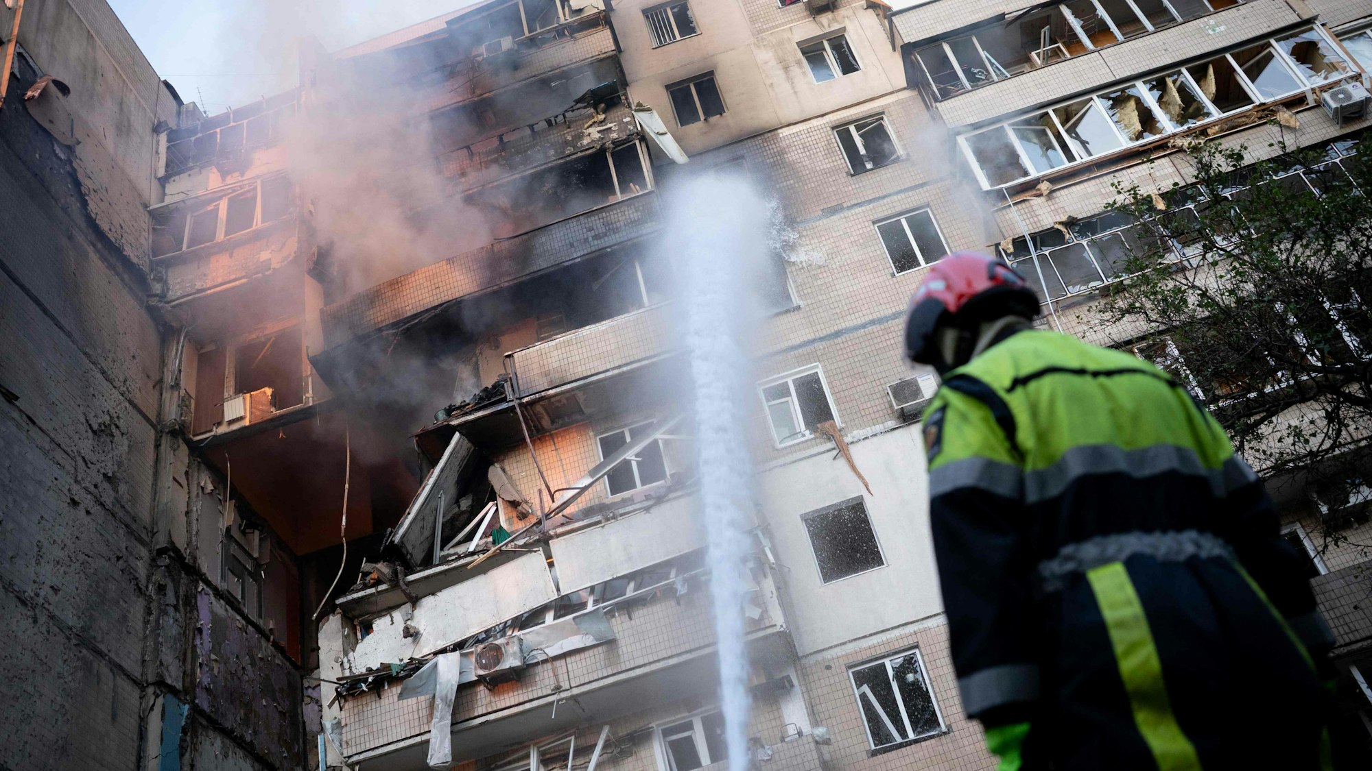 A firefighter works at a heavily damaged residential building following Russian drone and missile strikes in Kyiv on September 7, 2025, amid the Russian invasion of Ukraine. Russia fired its biggest-ever aerial barrage at Ukraine early on September 7, setting the seat of the Ukrainian government in Kyiv ablaze, authorities said. (Photo by Oleksandr Magula / AFP)