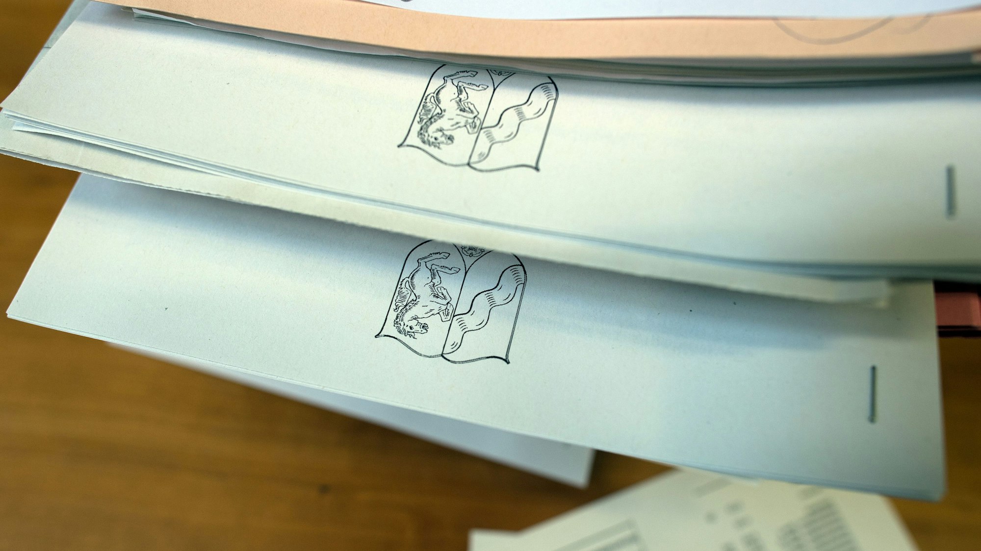 Die Akten von fünf Asyl-Verfahren liegen in einem Verhandlungssaal auf dem Richtertisch.