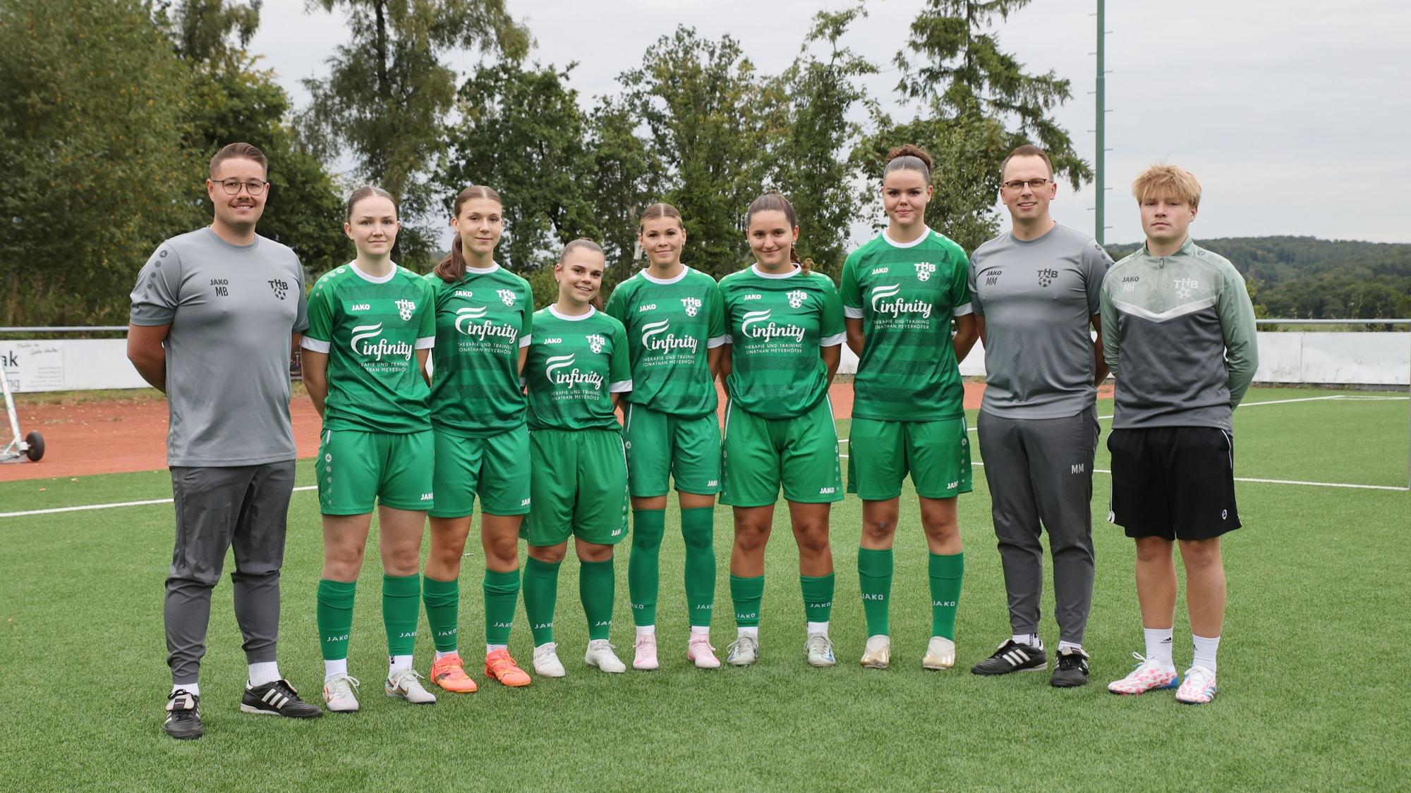 Gruppenbild mit Fußballerinnen und ihren Trainern