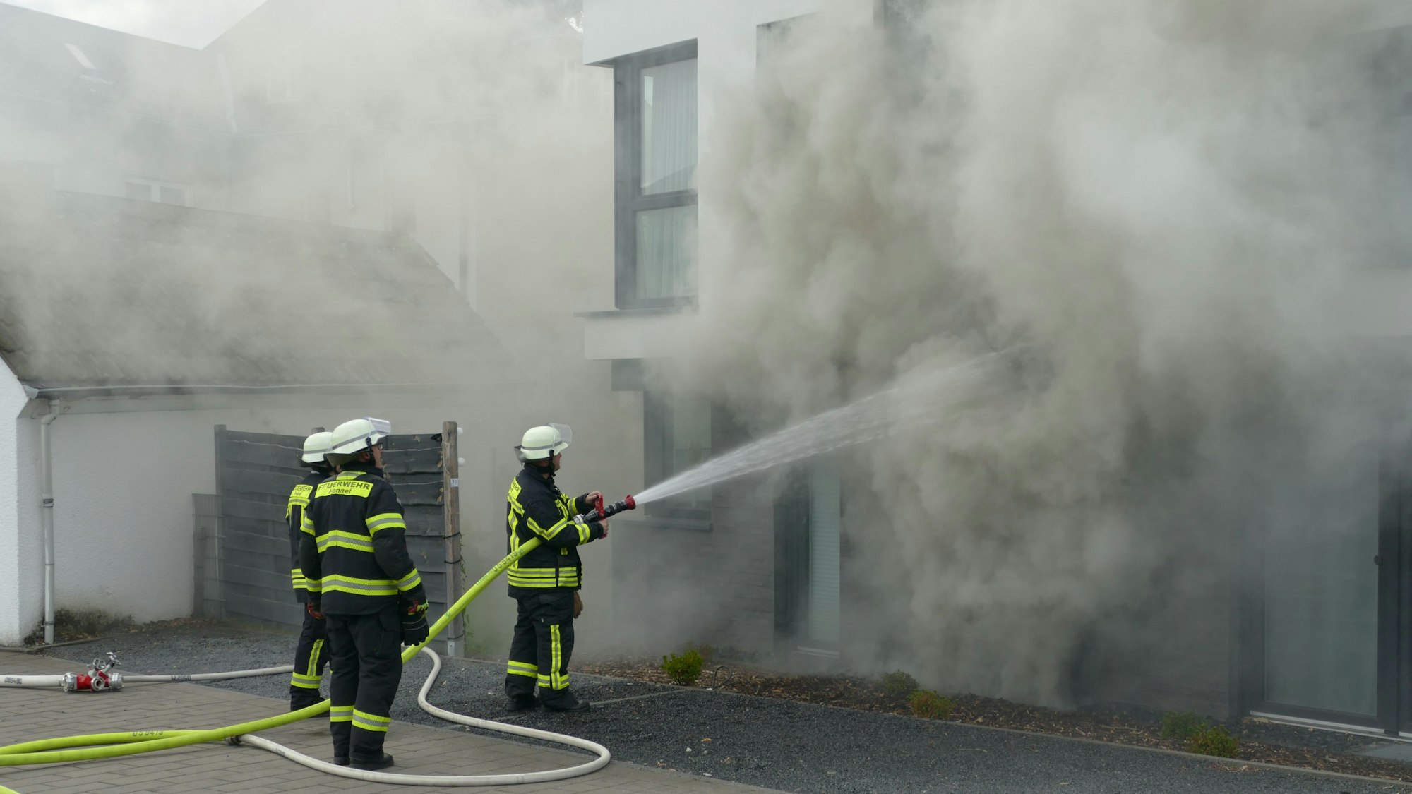 Einsatzkräfte der Feuerwehr an einem Brandort.